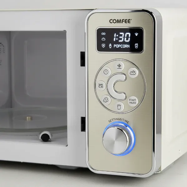 Close-up of Comfee retro microwave control panel with knob and buttons for easy use.