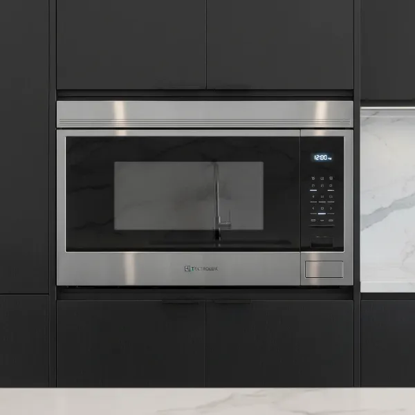 Electrolux built-in convection microwave with stainless steel finish seamlessly integrated into modern kitchen cabinetry.