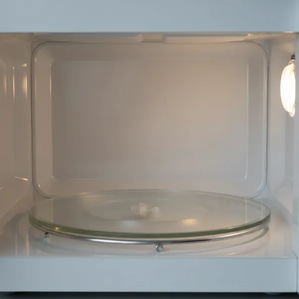 Close-up view of a Sharp Carousel microwave interior with the rotating glass turntable
